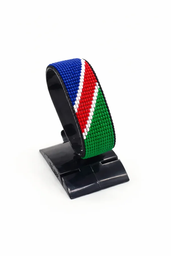Handcrafted Namibia flag bracelet made with red and white beads, adjustable beaded wrist accessory, displayed on a black stand