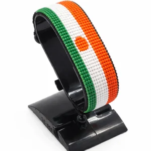 Handcrafted Niger flag bracelet made with red and white beads, adjustable beaded wrist accessory, displayed on a black stand