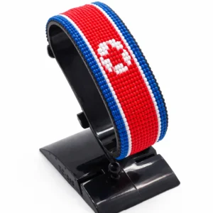 Handcrafted North Korea flag bracelet made with red and white beads, adjustable beaded wrist accessory, displayed on a black stand