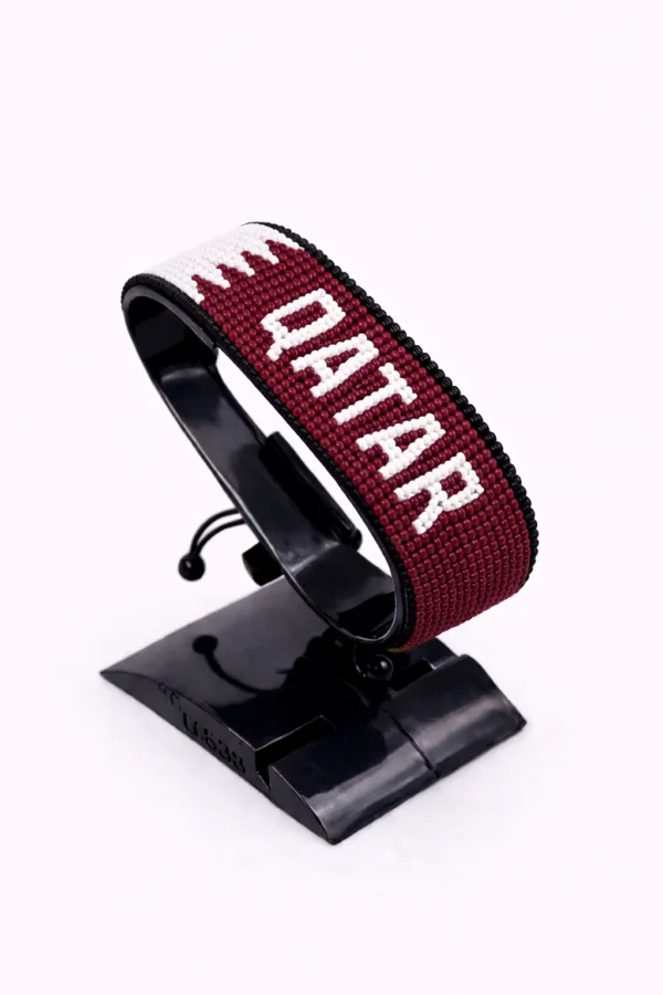 Qatar flag bracelet handcrafted in authentic flag colors on Black Stand.