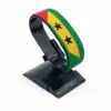 Handcrafted São Tomé and Príncipe flag bracelet made with red and white beads, adjustable beaded wrist accessory, displayed on a black stand