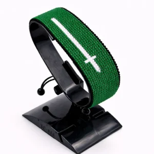 Handcrafted Saudi flag bracelet made with red and white beads, adjustable beaded wrist accessory, displayed on a Black stand