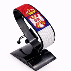 Handcrafted Serbia flag bracelet made with red and white beads, adjustable beaded wrist accessory, displayed on a black stand