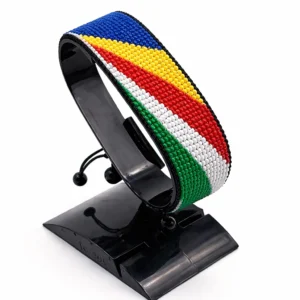 Handcrafted Seychelles flag bracelet made with red and white beads, adjustable beaded wrist accessory, displayed on a black stand