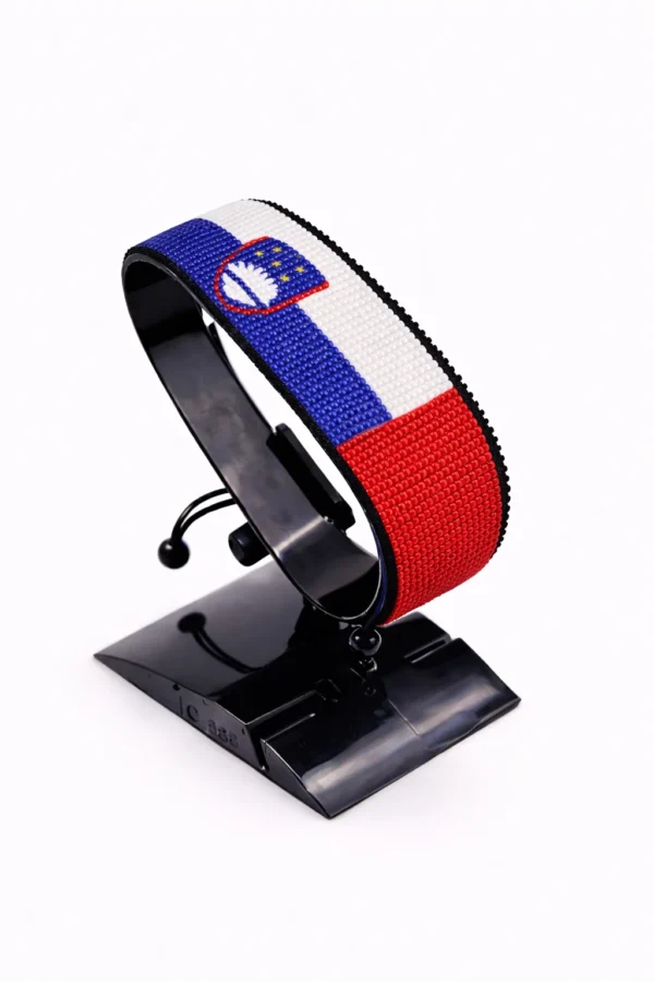 Handcrafted Slovenia flag bracelet made with red and white beads, adjustable beaded wrist accessory, displayed on a black stand