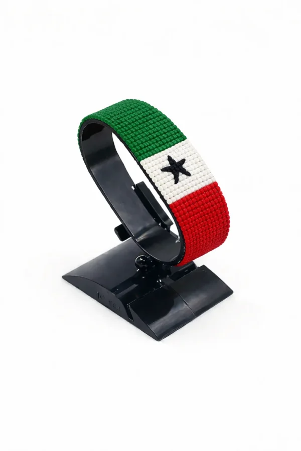 Handcrafted Somaliland flag bracelet made with red and white beads, adjustable beaded wrist accessory, displayed on a black stand