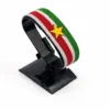 Handcrafted Suriname flag bracelet made with red and white beads, adjustable beaded wrist accessory, displayed on a black stand