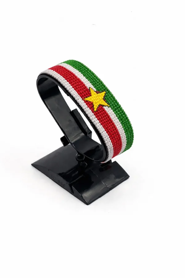 Handcrafted Suriname flag bracelet made with red and white beads, adjustable beaded wrist accessory, displayed on a black stand