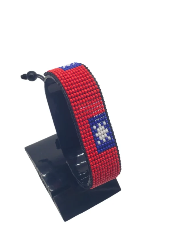 Handcrafted Taiwan flag bracelet, adjustable beaded wrist accessory, displayed on a black stand.