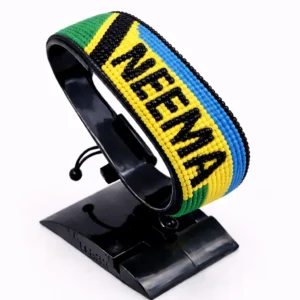 Handcrafted Tanzania with Name flag bracelet, adjustable beaded wrist accessory, displayed on a black stand.