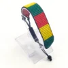 Handcrafted Togo flag bracelet with Name, adjustable beaded wrist accessory, displayed on a Clear stand.