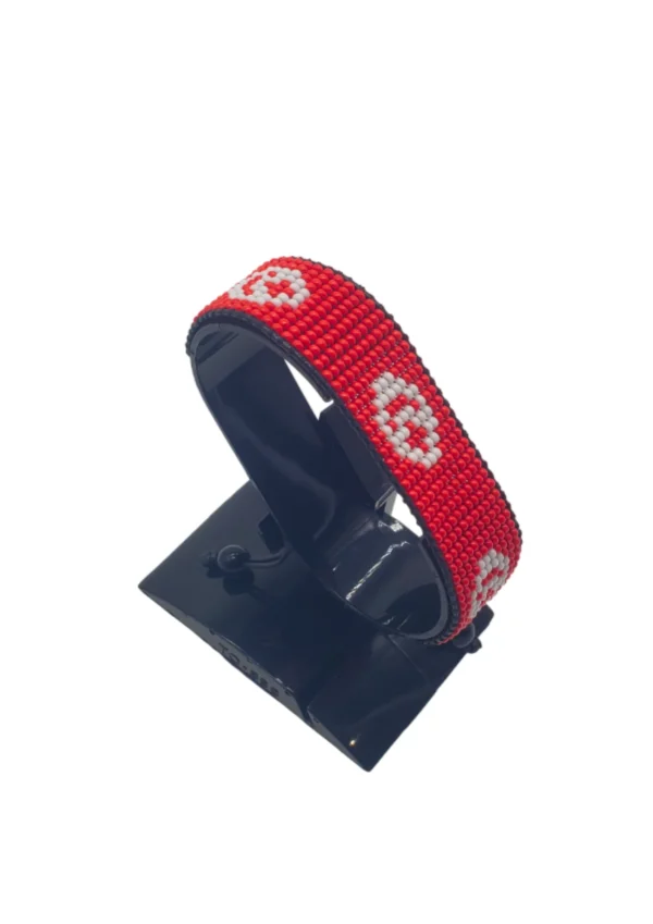 Handcrafted Tunisia flag bracelet, adjustable beaded wrist accessory, displayed on a black stand.