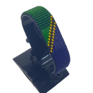 Handcrafted Tanzania flag bracelet, adjustable beaded wrist accessory, displayed on a black stand.