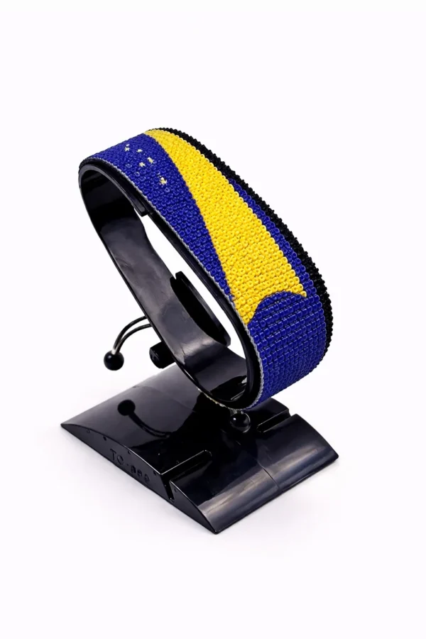 Handcrafted Tokelau flag bracelet with Name, adjustable beaded wrist accessory, displayed on a black stand.