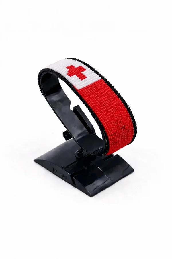 Handcrafted Tonga flag bracelet with Name, adjustable beaded wrist accessory, displayed on a black stand.