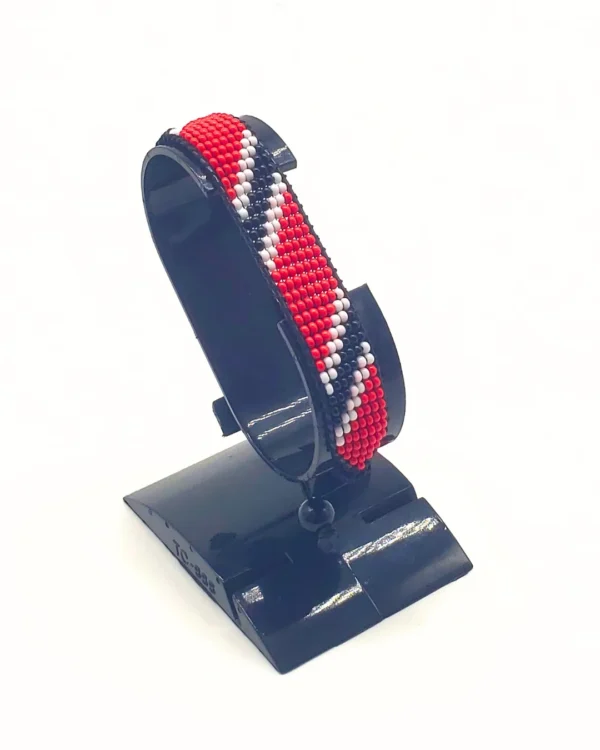 Handcrafted Trinidad & Tobago flag bracelet with Name, adjustable beaded wrist accessory, displayed on a black stand.