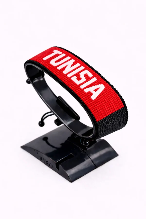 Handcrafted Tunisia flag bracelet with Name, adjustable beaded wrist accessory, displayed on a black stand.