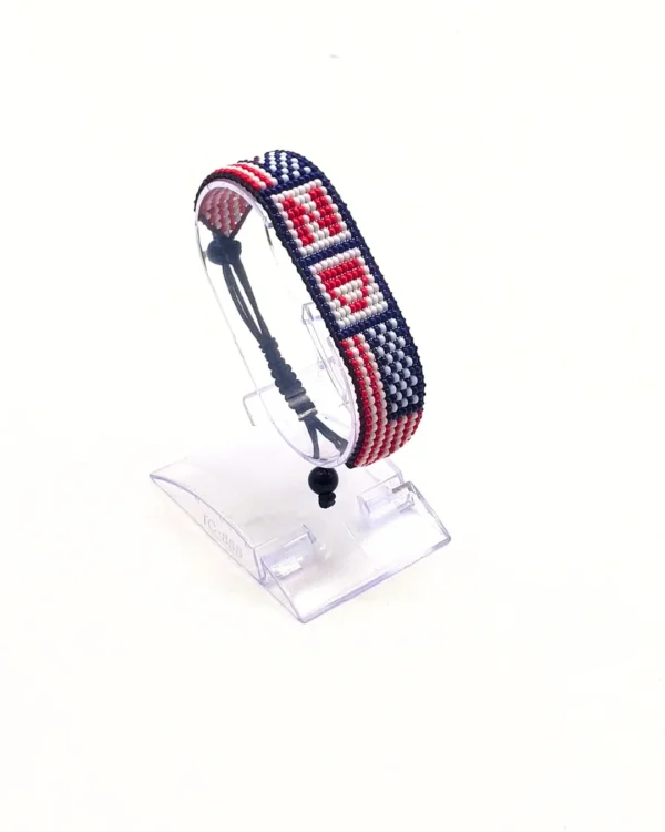 Handcrafted USA flag bracelet made with red and white beads, adjustable beaded wrist accessory, displayed on a Clear stand.
