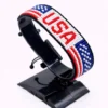 Handcrafted USA flag bracelet made with red and white beads, adjustable beaded wrist accessory, displayed on a black stand.