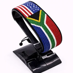 Handcrafted USA South Africa Combo flag bracelet made with red and white beads, adjustable beaded wrist accessory, displayed on a Clear stand.