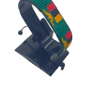 Handcrafted Zambia flag bracelet made with fine beads in green, red, black, and orange, adjustable beaded wrist accessory, displayed on a black stand.