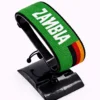Handcrafted Zambia name flag bracelet made with green, red, black, and orange beads, featuring the name “Zambia,” adjustable beaded wrist accessory, displayed on a black stand.