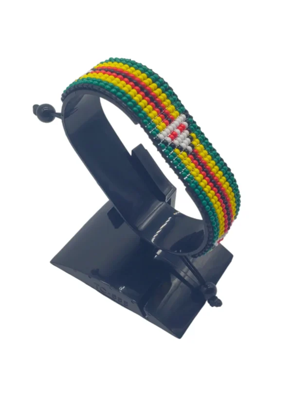 Handcrafted Zimbabwe flag bracelet made with green, yellow, red, black, and white beads, adjustable beaded wrist accessory, displayed on a black stand.