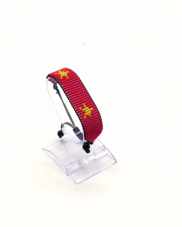 China flag bracelet handcrafted in authentic flag colors on Clear Stand.