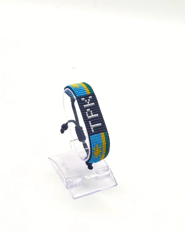 Rwanda flag bracelet handcrafted in authentic flag colors on Clear Stand.