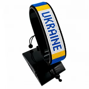 Ukraine Flag Bracelet With Name Adjustable handcrafted with beadwork in the colors of the Ukraine flag featuring the name UKRAINE